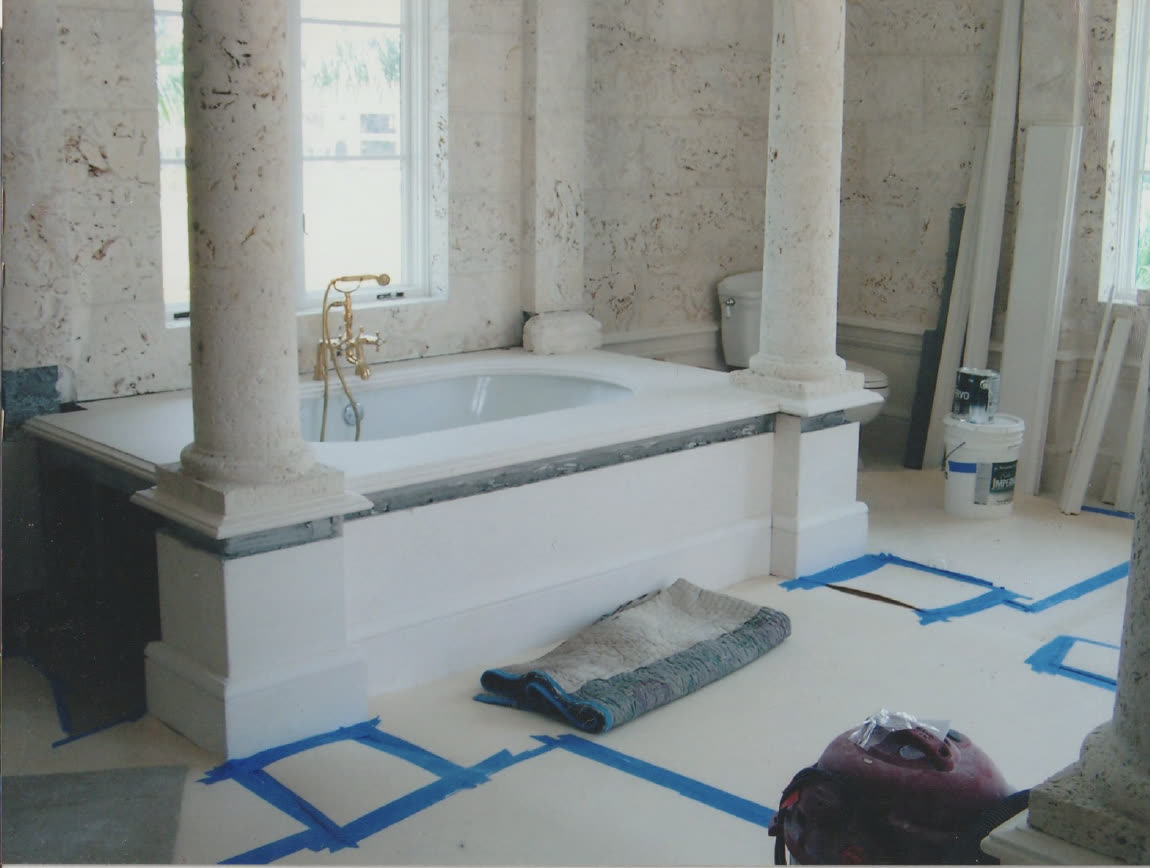 Coral stone bath with fabricated marble columns and tub surround by Luis's Home Repairs