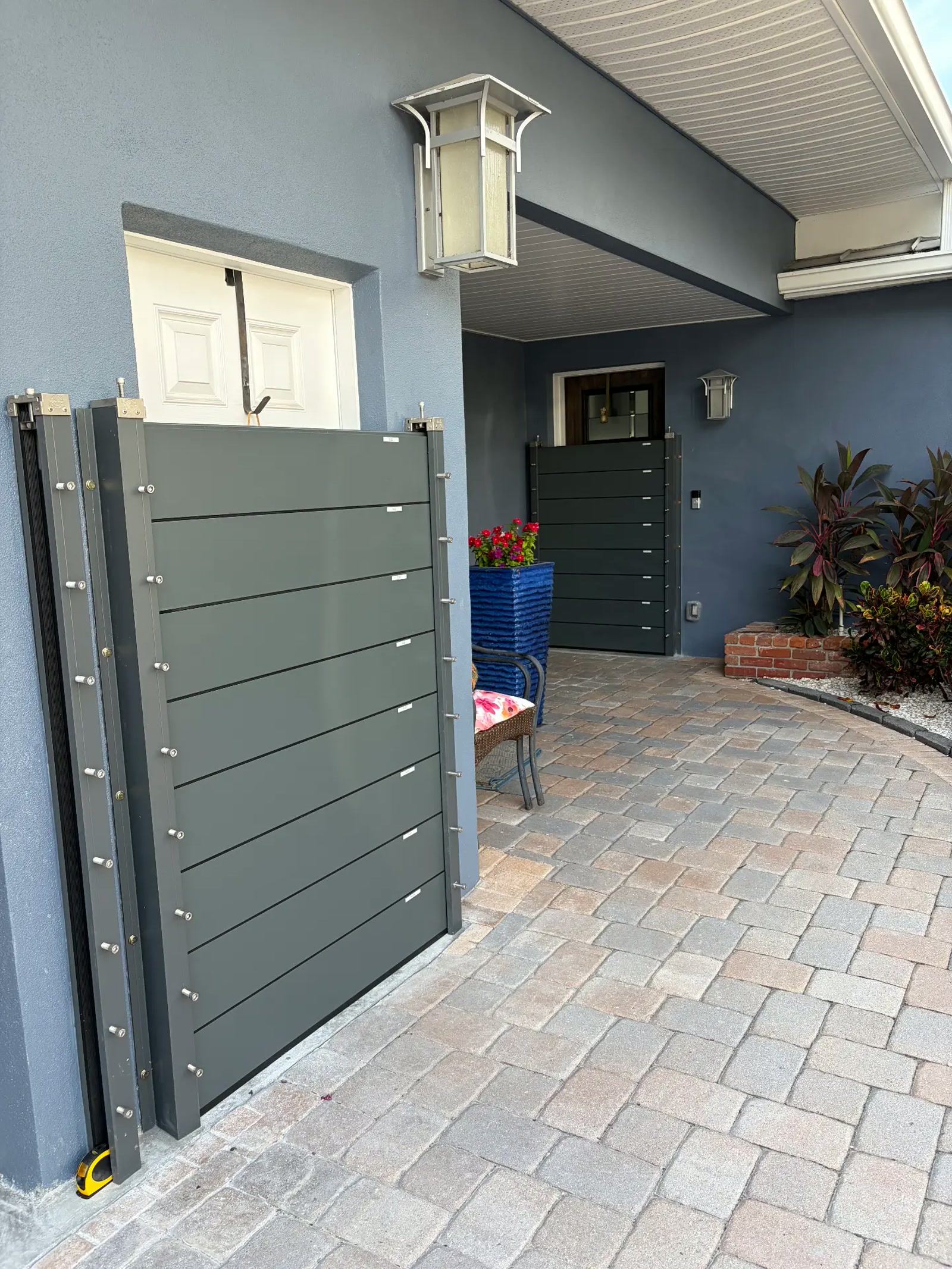 Custom metal gate and outdoor hardscape installation by Luis's Home Repairs